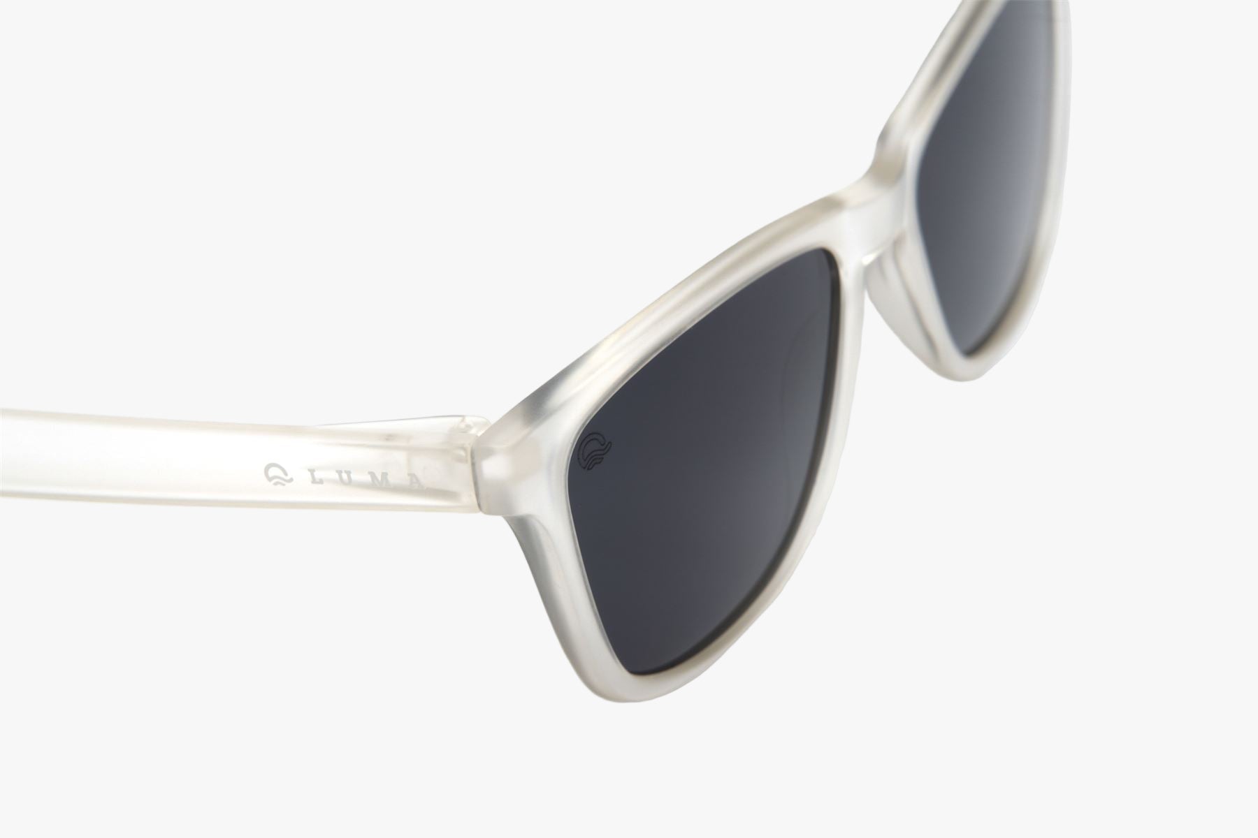 Sunglasses with white frame and dark lenses on a white background