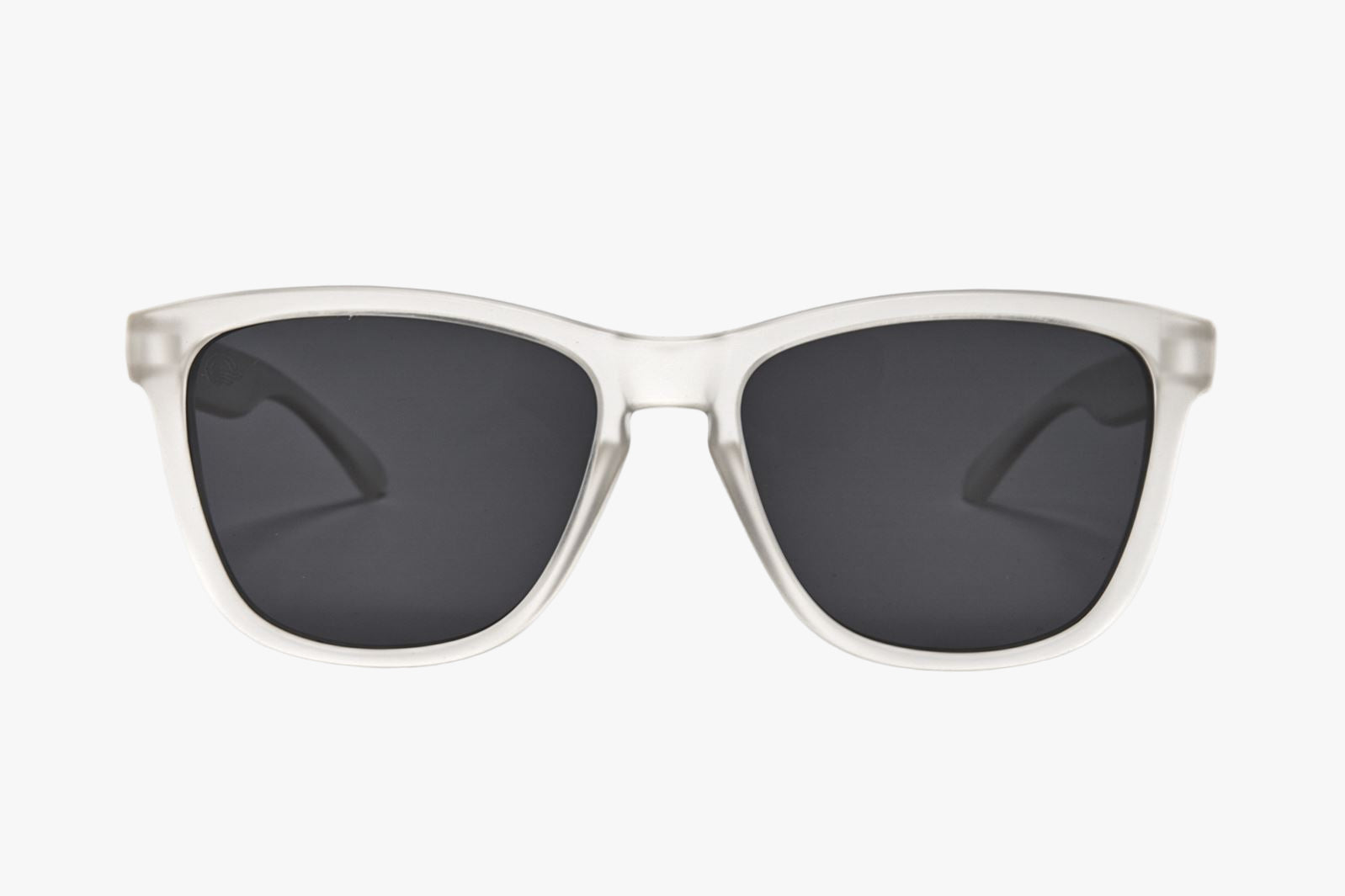 Sunglasses with clear frame and dark lenses on a white background