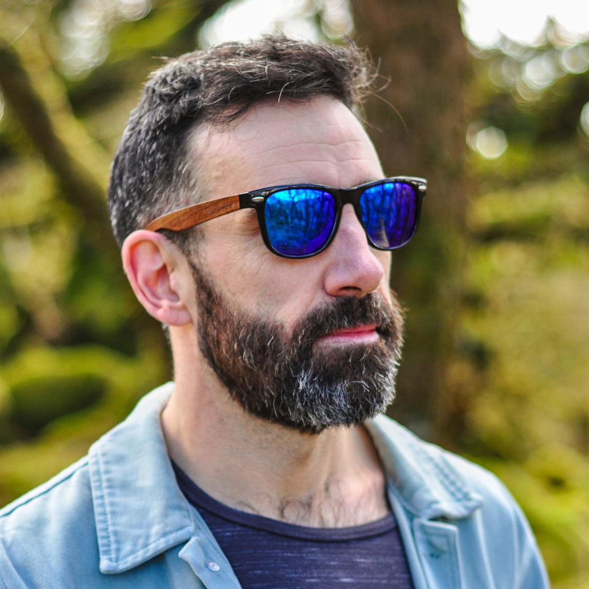 Man wearing sunglasses with a blurred natural background