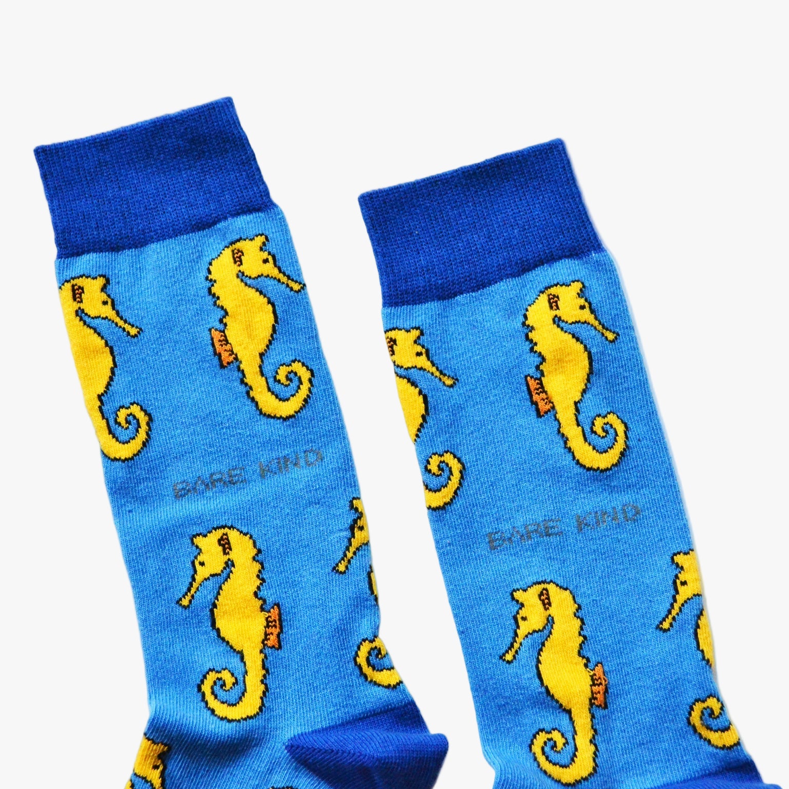 Blue Bare Kind socks with yellow seahorses.