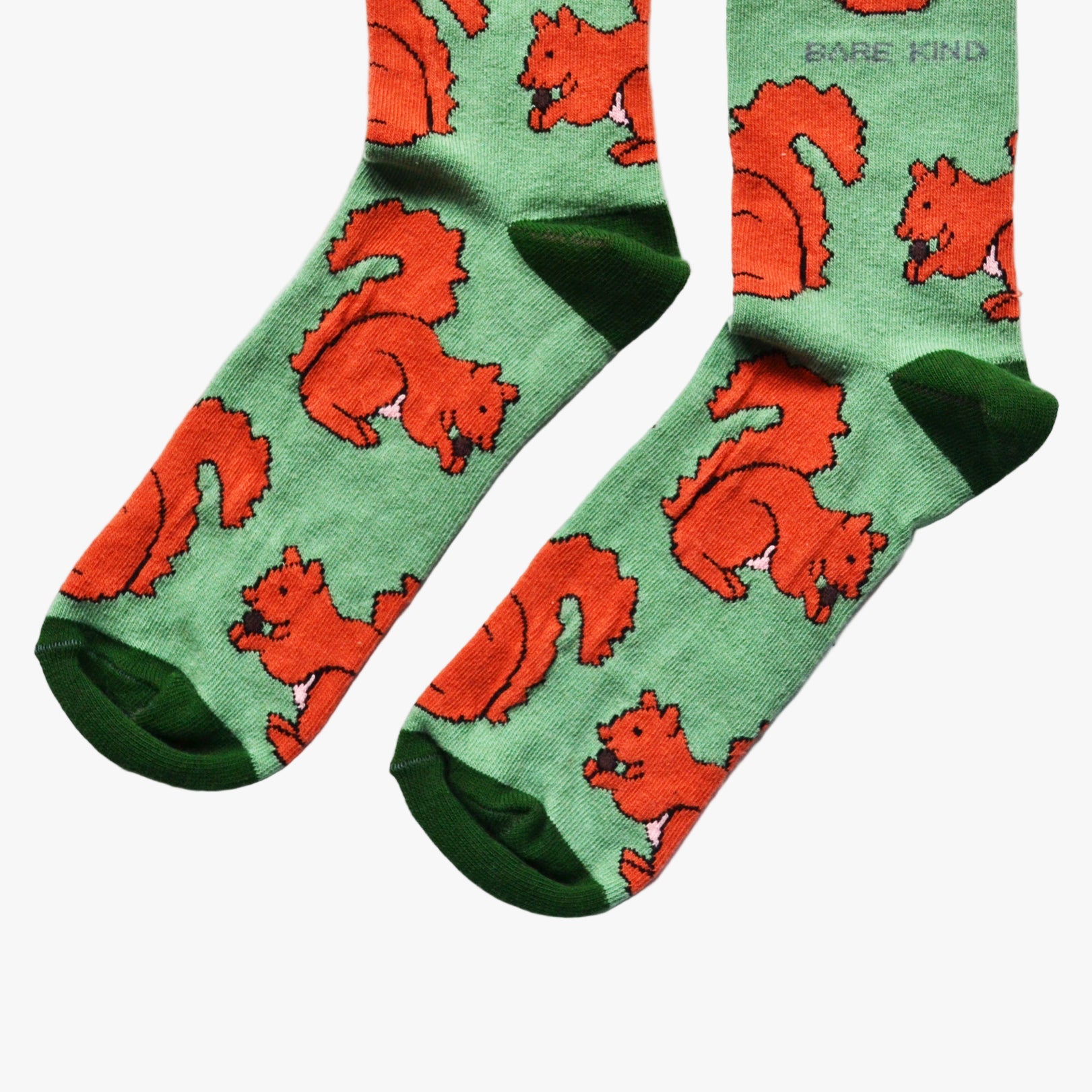 Green socks with red squirrel pattern on a white background