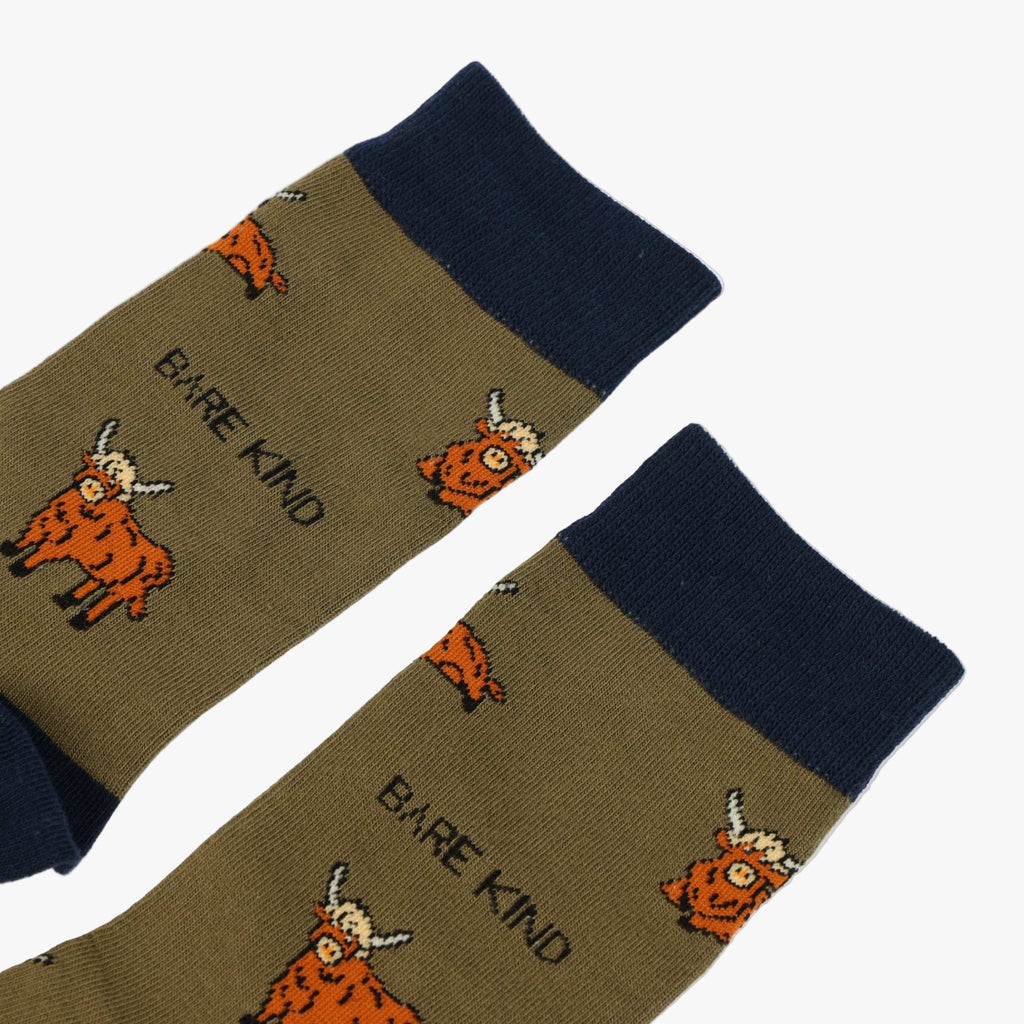 Pair of socks with cartoon cow design and 'Bare Kind' text on a white background