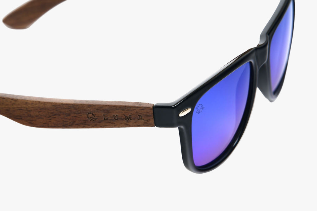 Sunglasses with wooden frame and blue lenses on a white background