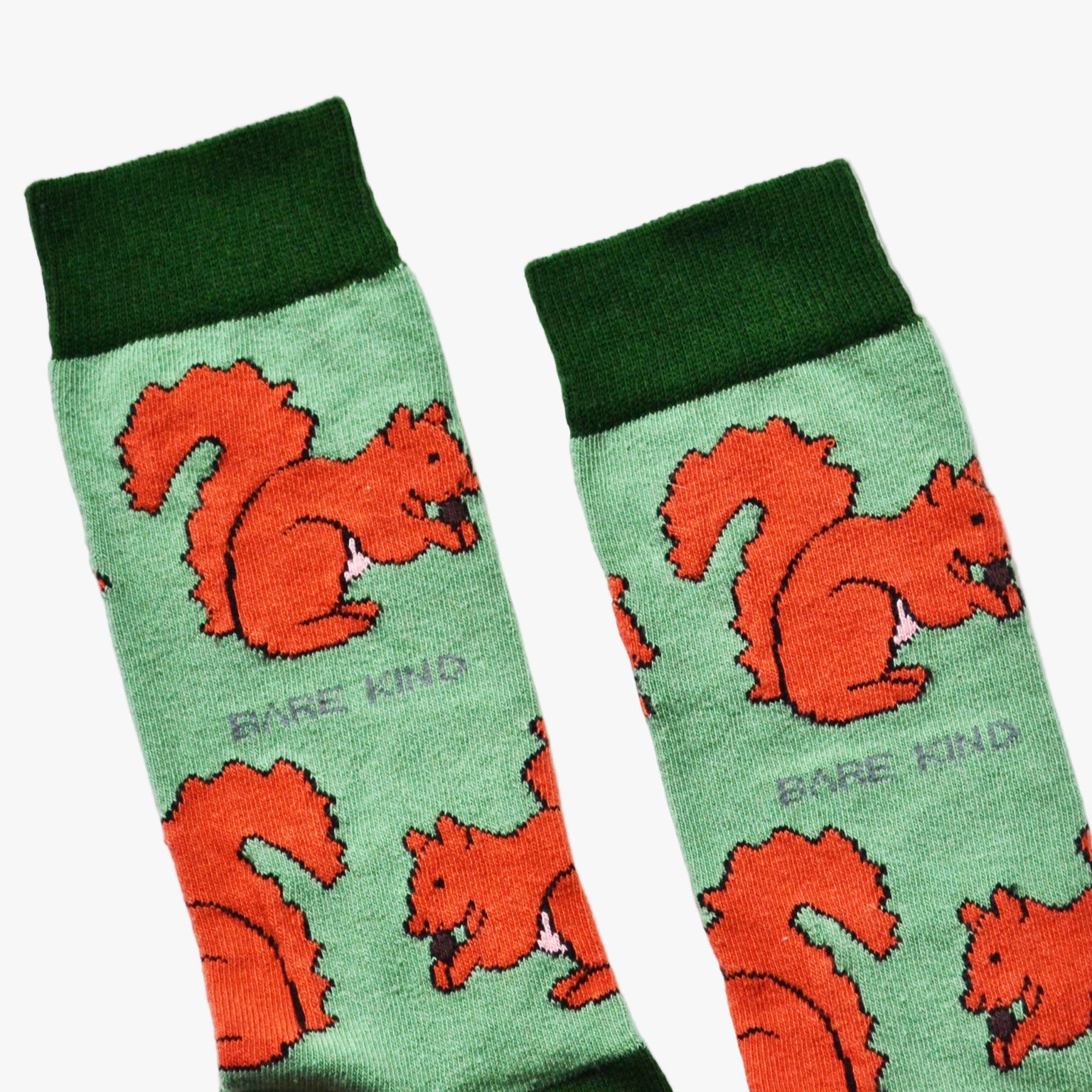 Pair of socks with red squirrel design on a green background