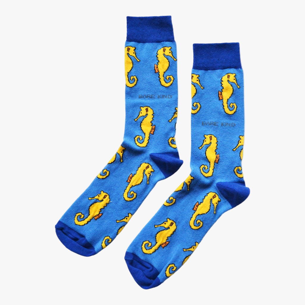 Blue socks with yellow seahorse pattern on a white background