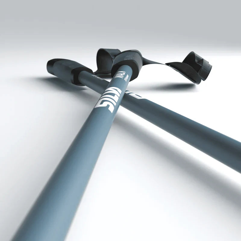 Two gray walking poles with black grips on a light gray background