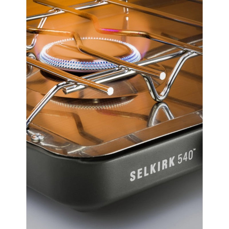 Close-up of a Selkirk 540 camping stove with visible flame.