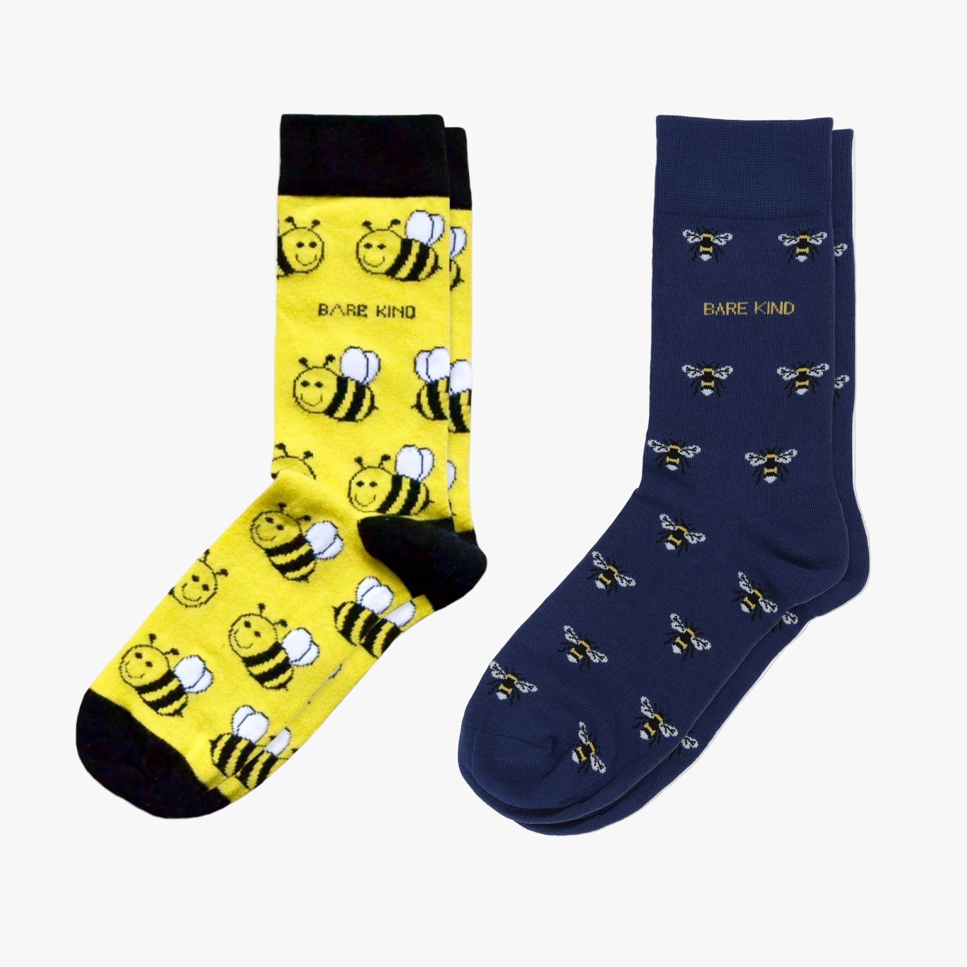 Two pairs of socks, one yellow with bee patterns and one navy with bee patterns, on a white background.